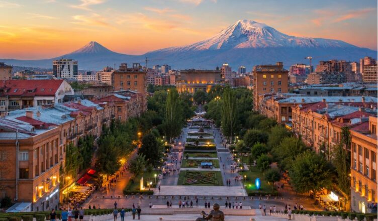 Evening panoramic view of central Yerevan with Cascade Complex, city lights and Mount Ararat in the background