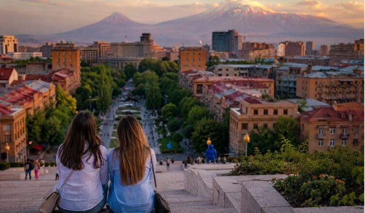 Travelers enjoying an evening view of Yerevan from the Cascade with Mount Ararat in the background
