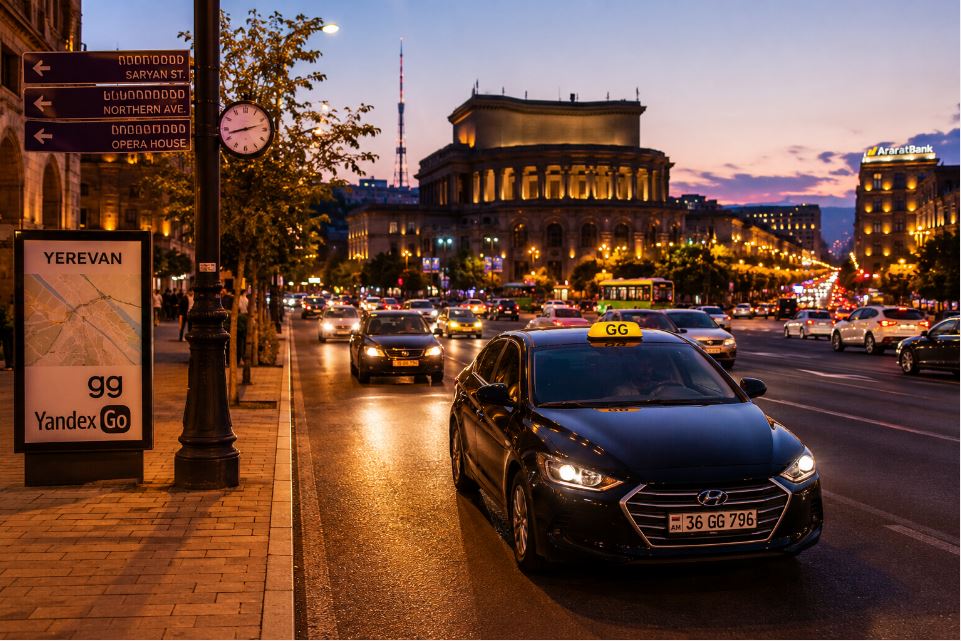 Evening traffic in central Yerevan with GG taxi, Opera House and local transportation atmosphere