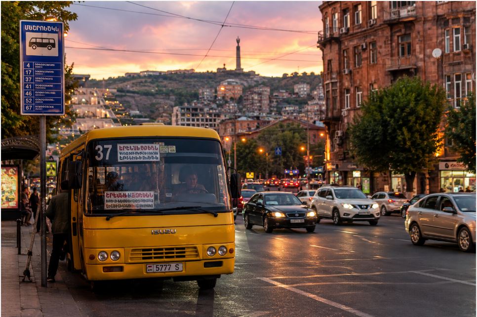 Traditional marshrutka minibus on evening streets of Yerevan with local transportation atmosphere
