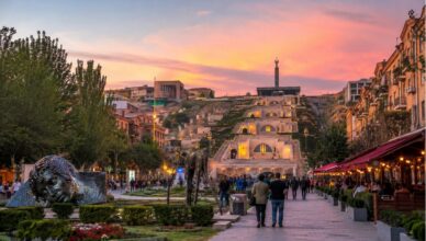 Everyday evening life in Yerevan with locals walking and talking on a warm city street