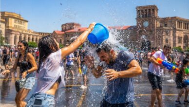 People celebrating Vardavar with buckets of water in Republic Square, Yerevan