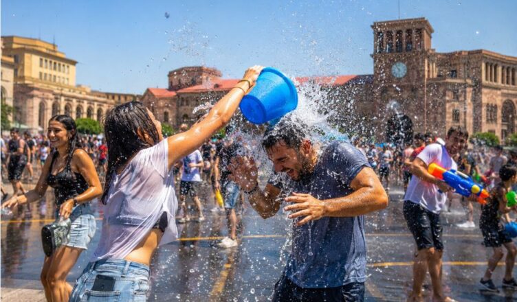 People celebrating Vardavar with buckets of water in Republic Square, Yerevan